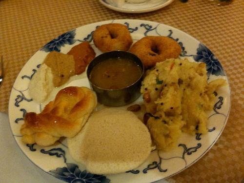 a plate of different types of food on a table at PRS CREEK SIDE HOME STAY VILLA in Yelagiri