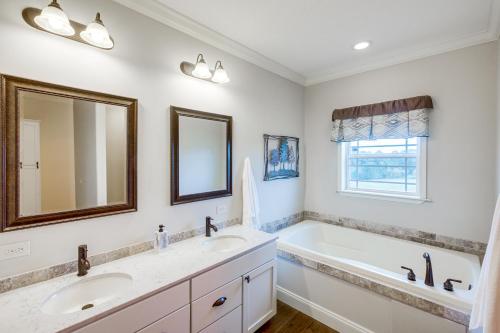 a bathroom with two sinks and a tub and a mirror at Crossville Home Near Lake Tansi and Hiking Trails! in Crossville