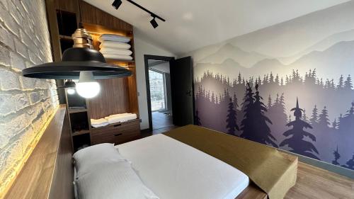 a bedroom with a bed with a forest mural on the wall at DrVillaSuits Casa Riva in Belek