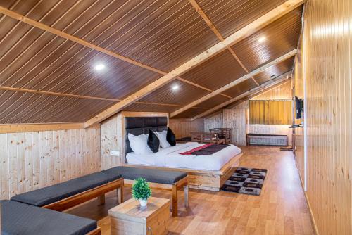 a bedroom with a bed and a couch in a room at The Tikker in Shimla