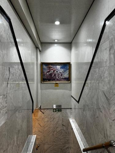 a bathroom with a painting on the wall at Berkley Apartments in London