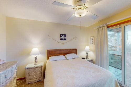 a bedroom with a bed with two night stands and two lamps at Surfs Inn #35-5 in Avon