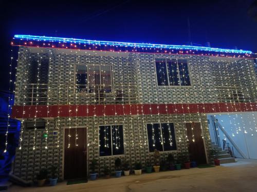 a building with christmas lights on it at Pradhan Homestay Mirik - Homestay beside Mirik Lake in Mirik