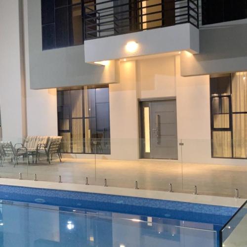 a building with a swimming pool in front of it at بيت الشرقية in Mazra‘at Shuway‘ī