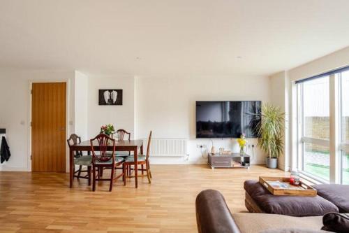 a living room with a table and a dining room at The Nest of Forest Hill in Forest Hill