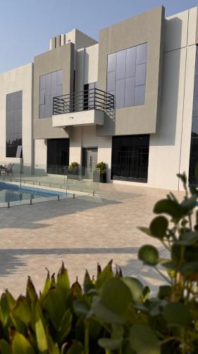 a building with a pool in front of it at بيت الشرقية in Mazra‘at Shuway‘ī