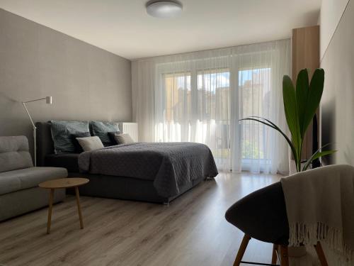 a bedroom with a bed and a couch at River Living Apartman in Budapest