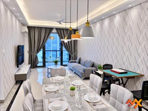 a living room with a table and a couch at R&F Mall Princess Cove 10-12pax Sea View-Smart TV 70inch in Johor Bahru