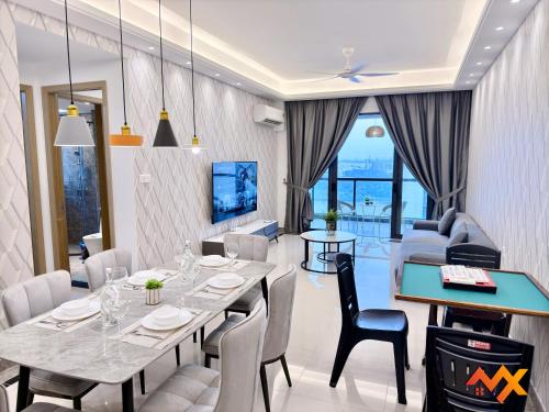 a dining room with a table and chairs at R&F Mall Princess Cove 10-12pax Sea View-Smart TV 70inch in Johor Bahru