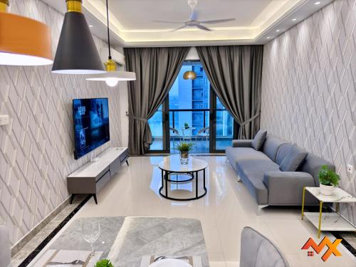 a living room with a couch and a tv at R&F Mall Princess Cove 10-12pax Sea View-Smart TV 70inch in Johor Bahru