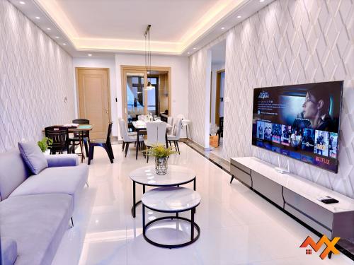 a living room with a large tv on a wall at R&F Mall Princess Cove 10-12pax Sea View-Smart TV 70inch in Johor Bahru