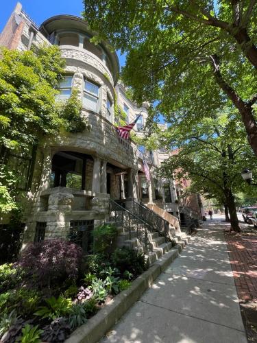 a stone building with an american flag on it at 2F Chicago's Little Italy near West Loop & Downtown in Chicago