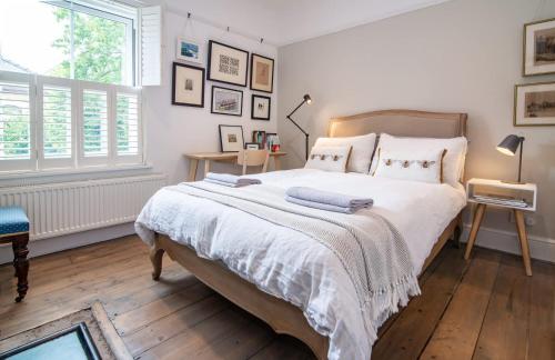 a bedroom with a large bed with white sheets and pillows at Host & Stay - Terrace House on Canal in Worcester