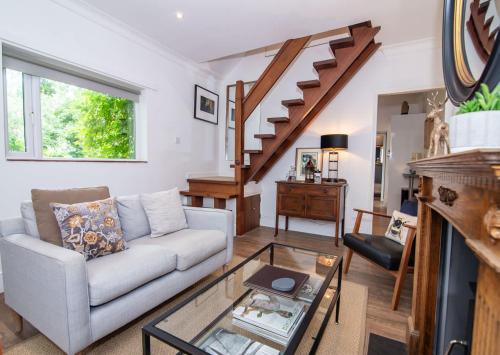 a living room with a couch and a glass table at Host & Stay - Terrace House on Canal in Worcester