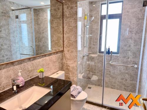 a bathroom with a shower and a sink and a toilet at R&F Mall Princess Cove 10-12pax Sea View-Smart TV 70inch in Johor Bahru