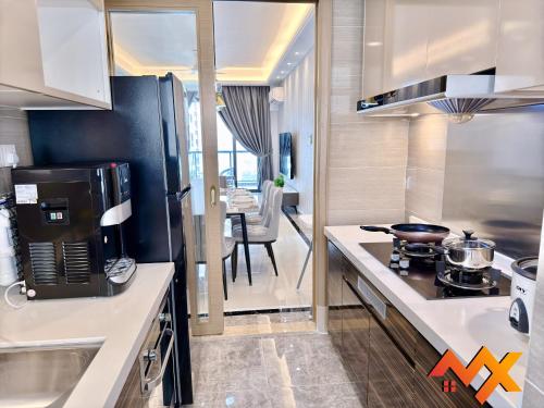 a kitchen with a sink and a stove top oven at R&F Mall Princess Cove 10-12pax Sea View-Smart TV 70inch in Johor Bahru