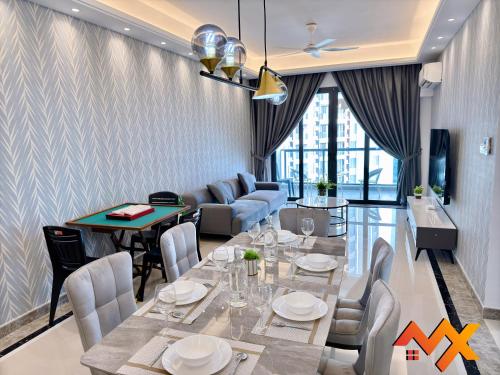 a dining room with a table and chairs at R&F Mall Princess Cove 10-12pax Sea View-Smart TV 70inch in Johor Bahru