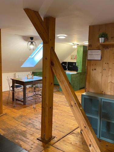 a wooden beam in a room with a kitchen and a table at Do pohody - Do přírody in Stoječín
