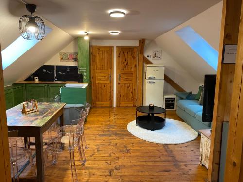 a kitchen and living room with a table and a couch at Do pohody - Do přírody in Stoječín
