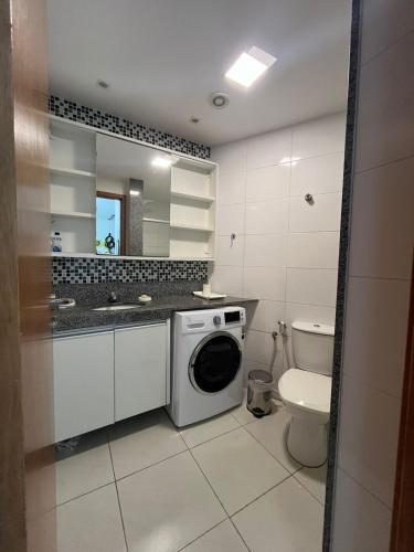 a bathroom with a washing machine and a toilet at Apto 304-D, 1 quarto completo! in Tamandaré