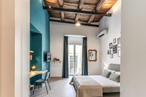 a bedroom with a bed and a desk in a room at NextStopPignasecca in Naples