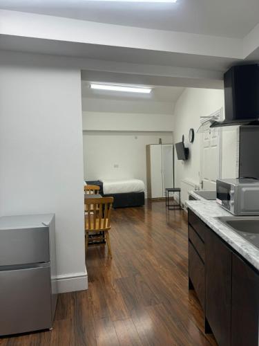 a room with a kitchen and a living room at Nikoda Lodge in Gillingham