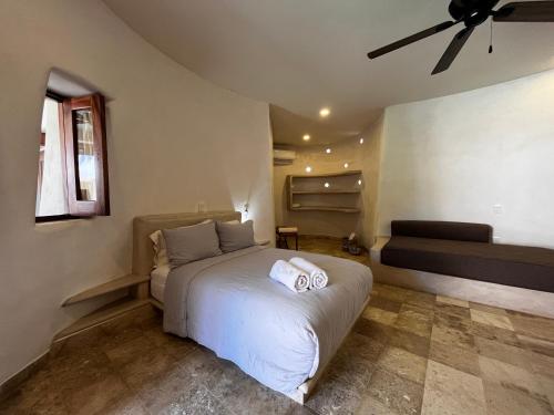 a bedroom with a white bed and a couch at Villas Cononda in La Majahua
