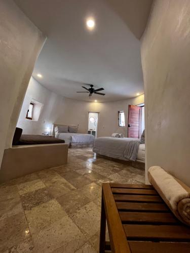 a bedroom with two beds and a ceiling fan at Villas Cononda in La Majahua