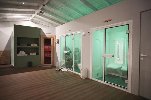 a room with glass doors and a room with a bathroom at Filoxenia Hotel & Spa in Kalavrita