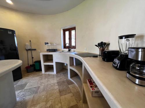 a kitchen with a counter and a counter top with a counter at Villas Cononda in La Majahua