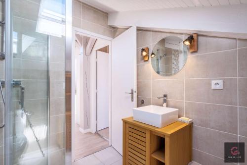 une salle de bain avec un lavabo et une douche dans l'établissement Biscarrosse Plage Villa avec piscine pour 12 personnes, à Biscarrosse-Plage