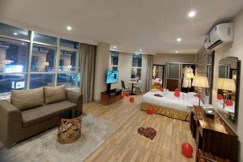 a hotel room with a bed and a living room at شقق دولف in Hafr Al Baten