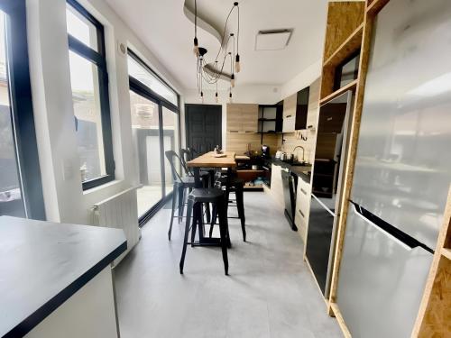 - une cuisine avec une table, des chaises et un miroir dans l'établissement Maison 43, à Rouen