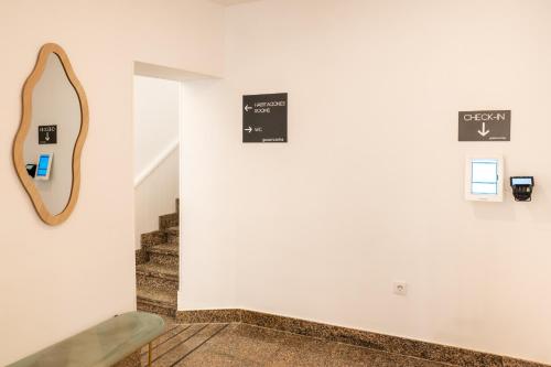 a hallway with a mirror and stairs at Hotel Gran Vía by gaiarooms in Salamanca