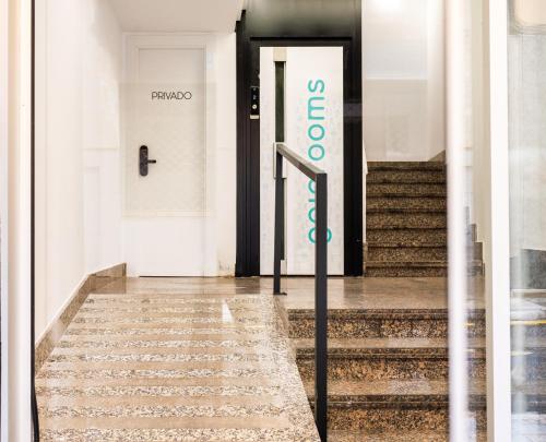 a sign on the door of a building with stairs at Hotel Gran Vía by gaiarooms in Salamanca