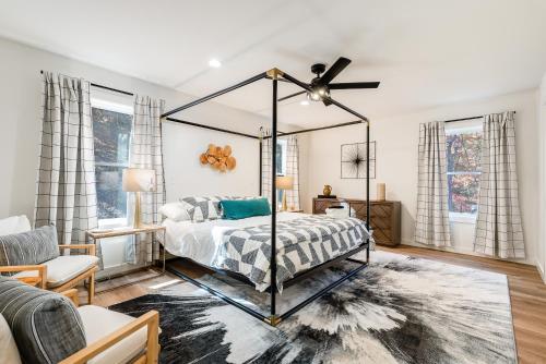 a bedroom with a canopy bed and a couch at Epic Mtn Views I Luxe 5br Alpine Escape in McGaheysville