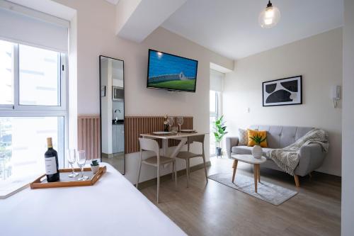 a bedroom with a bed and a living room at Connect Studios by Vibrant in Lima