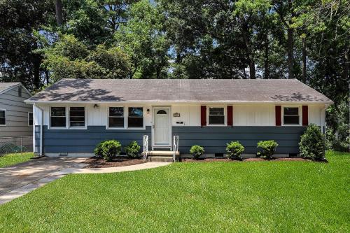 a blue and white house with a lawn at Rejuvenation and Relaxation in Virginia Beach