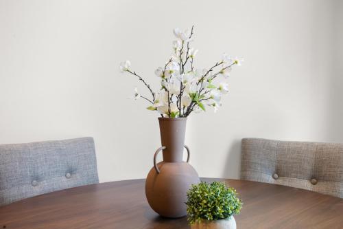 a vase with flowers in it on a table at 37b Orchard Hills Circle in Bernard