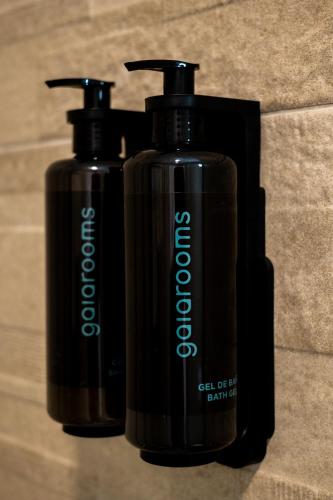 two black bottles are sitting next to each other at Hotel Gran Vía by gaiarooms in Salamanca