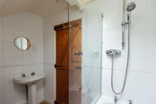 a bathroom with a shower and a sink at Birch Cottage - Tranquil Country Cottage with Indoor Swimming Pool in Haverfordwest