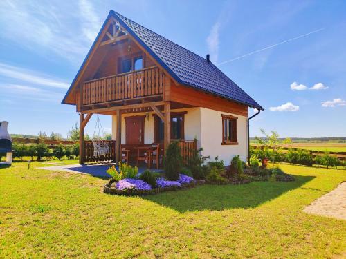 a small house with a gambrel roof at Domek u Lipków na Kaszubach "Iga" JACUZZI in Lipusz