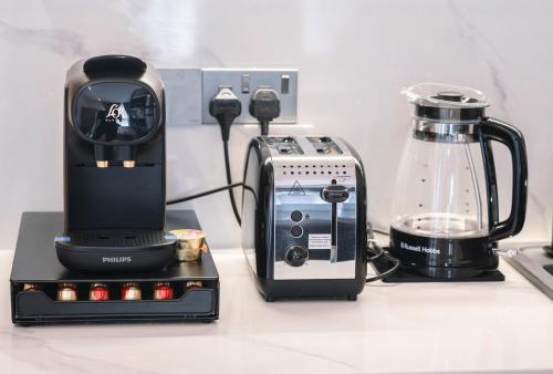 a blender and a toaster sitting on a counter at Luxury Studios by Home in Mpehuasem