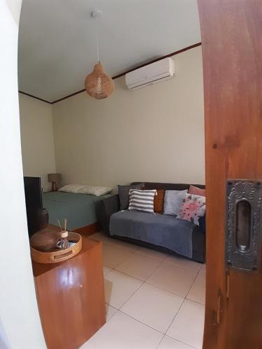 a living room with a couch and a bed at anik homestay & dormy Batukaras in Batukaras