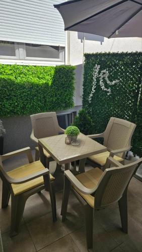 a table and chairs and an umbrella on a patio at TIHA VODA 4 in Požarevac