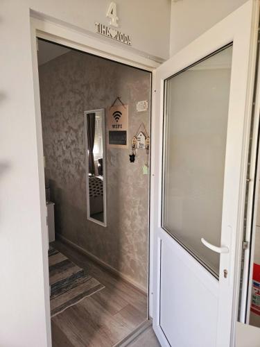 a door leading into a hallway with a mirror at TIHA VODA 4 in Požarevac