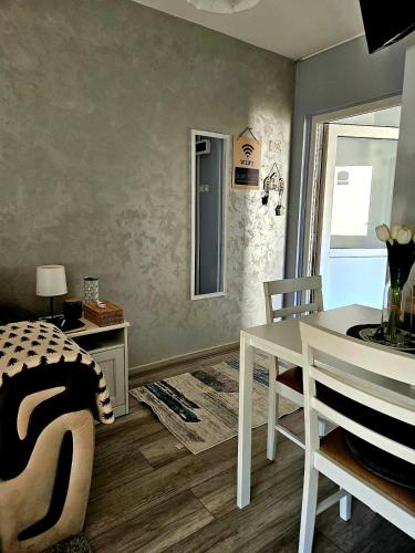 a dining room with a white table and chairs at TIHA VODA 4 in Požarevac