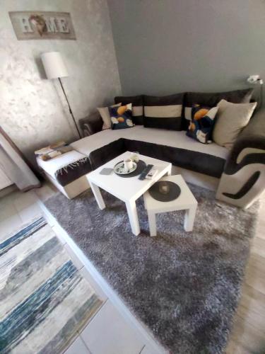 a living room with a couch and a table at TIHA VODA 4 in Požarevac