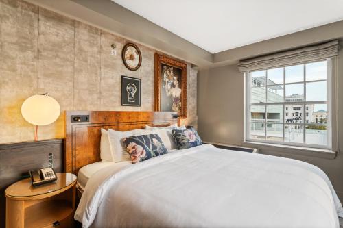 a bedroom with a large bed and a window at Hotel Indigo Baton Rouge Downtown by IHG in Baton Rouge