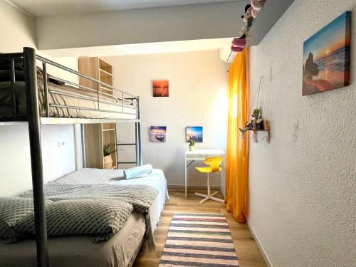 a bedroom with two bunk beds and a desk at Central loft apartments in Santa Pola